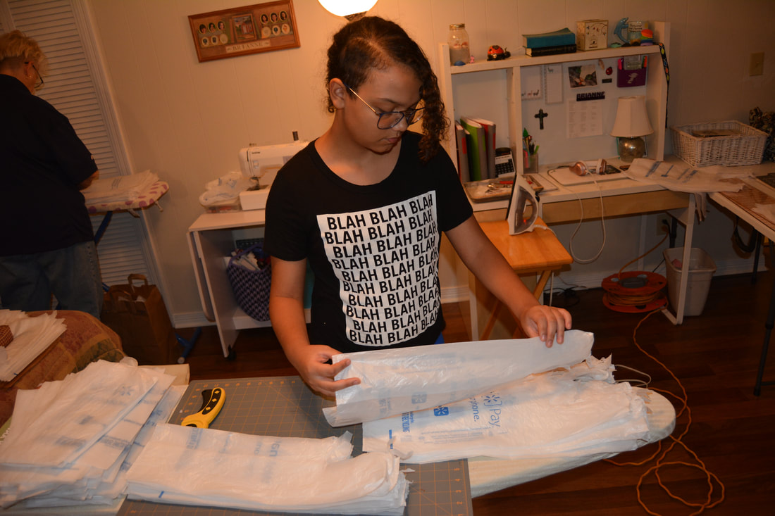 Girl arranging plastic bags.